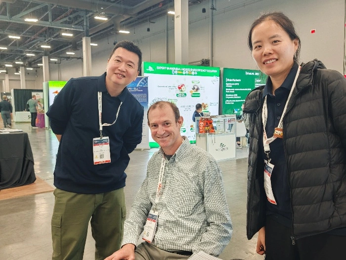 EmerWell team posing with valued client at SupplySide West 2025 booth